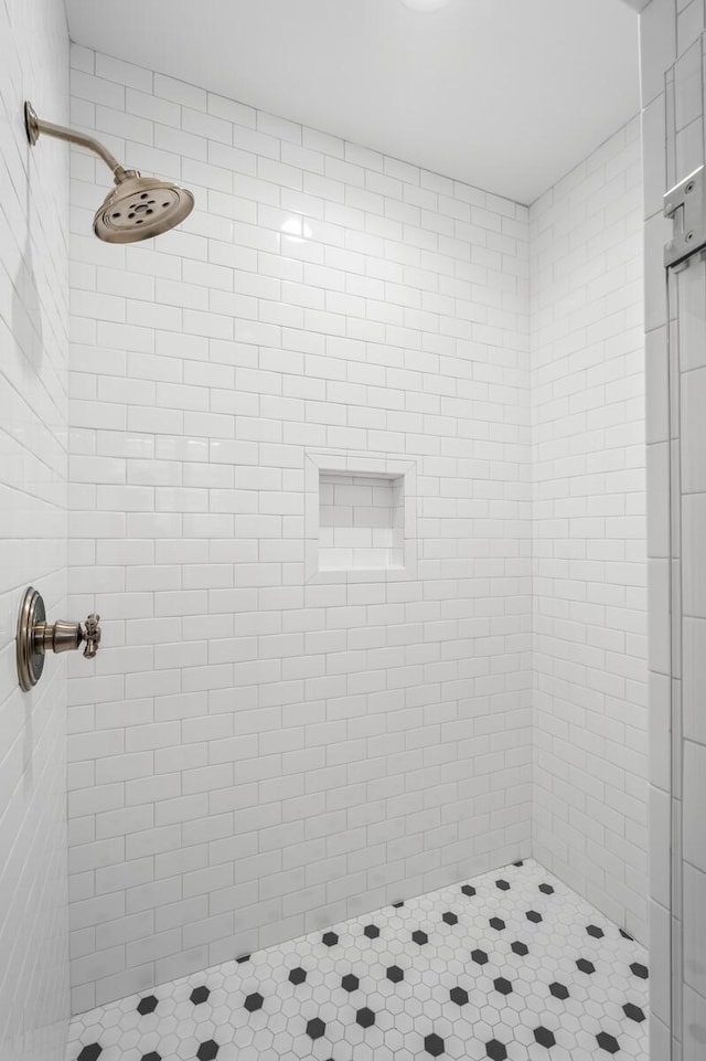 bathroom with a tile shower