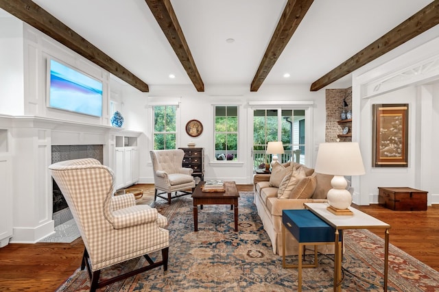 living room with beam ceiling and hardwood / wood-style flooring