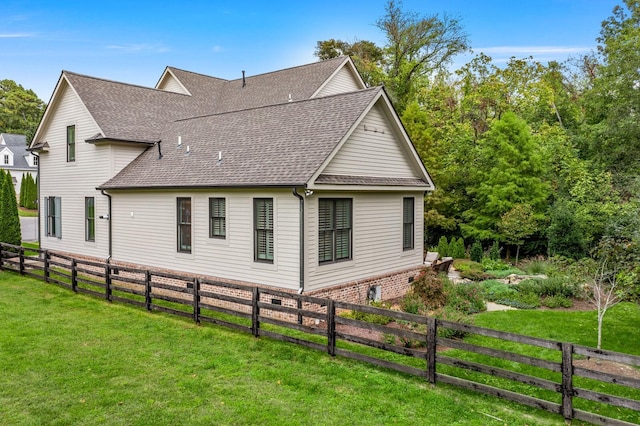 view of side of home featuring a lawn