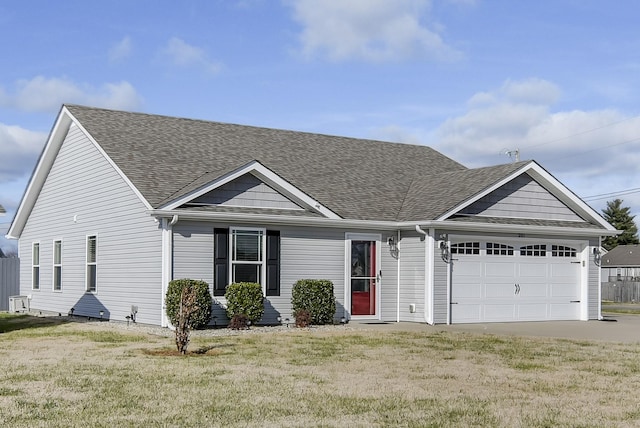 view of front of house featuring a front yard and a garage