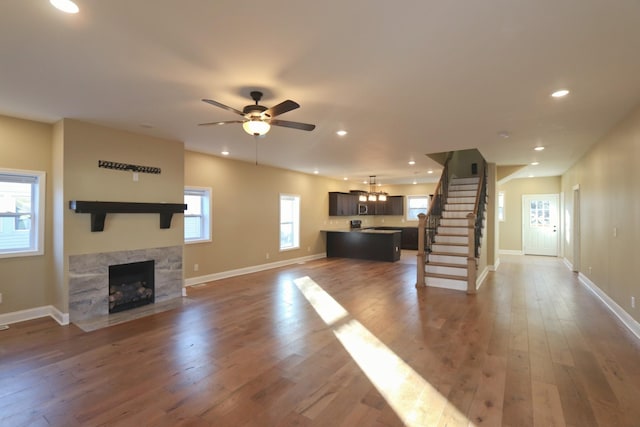 unfurnished living room featuring a wealth of natural light, a fireplace, and wood-type flooring