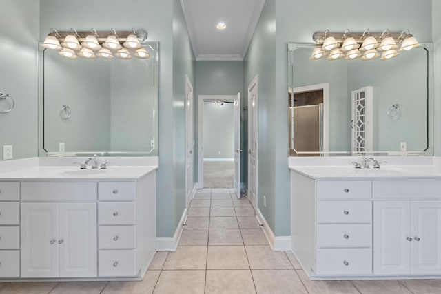 bathroom featuring tile patterned flooring, vanity, a shower with door, and ornamental molding