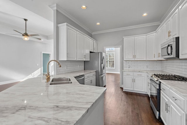 kitchen featuring white cabinets, sink, light stone countertops, tasteful backsplash, and stainless steel appliances