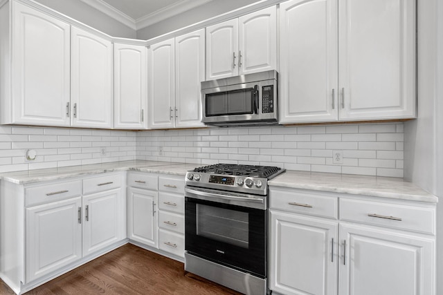 kitchen featuring decorative backsplash, white cabinetry, and stainless steel appliances