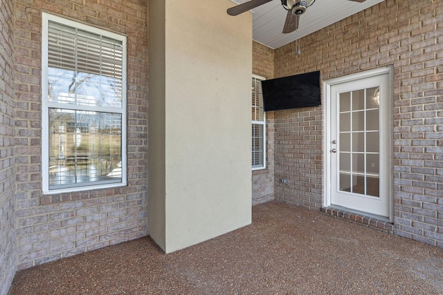 view of exterior entry featuring ceiling fan