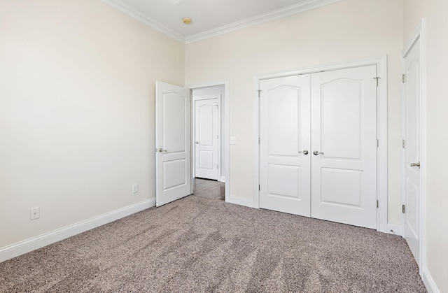 unfurnished bedroom featuring carpet floors, a closet, and ornamental molding