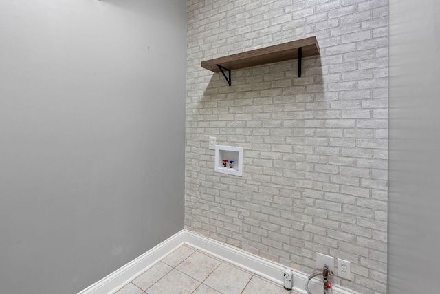 laundry area featuring washer hookup and light tile patterned floors