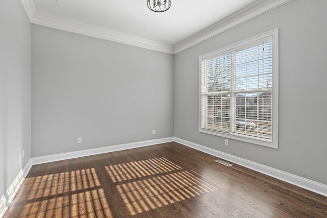 empty room featuring dark hardwood / wood-style flooring and crown molding