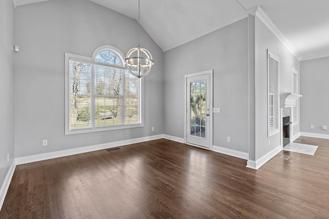 unfurnished dining area featuring a chandelier, dark hardwood / wood-style flooring, plenty of natural light, and vaulted ceiling