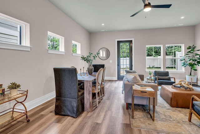 dining space featuring ceiling fan and light wood-type flooring