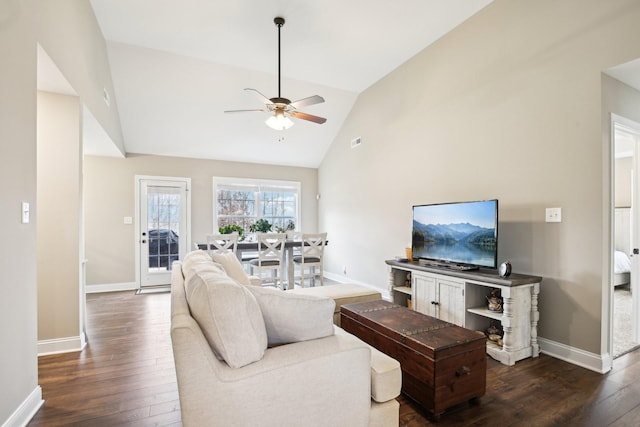 living room featuring dark hardwood / wood-style flooring, vaulted ceiling, and ceiling fan