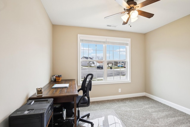 carpeted home office with ceiling fan