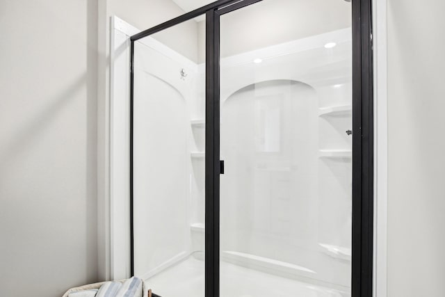 bathroom with a shower with door