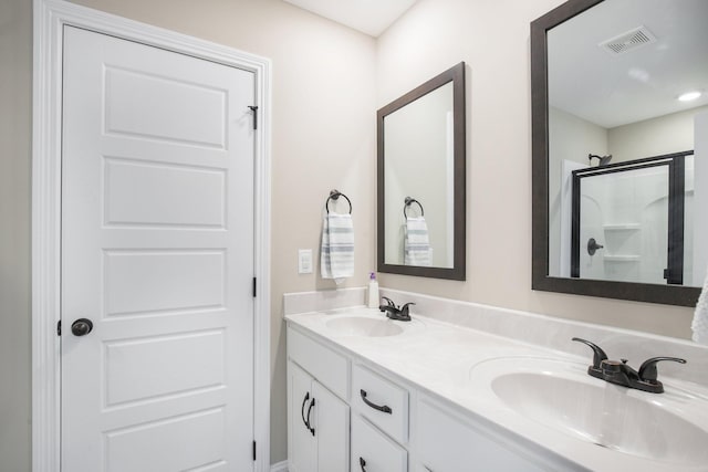 bathroom featuring vanity and a shower with door