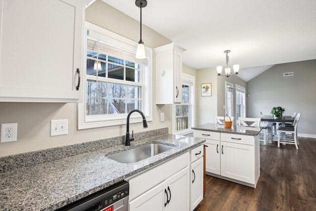 kitchen featuring sink, hanging light fixtures, a notable chandelier, light stone counters, and white cabinetry