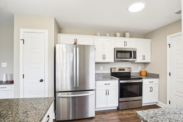 kitchen featuring white cabinetry, dark hardwood / wood-style flooring, light stone countertops, and appliances with stainless steel finishes