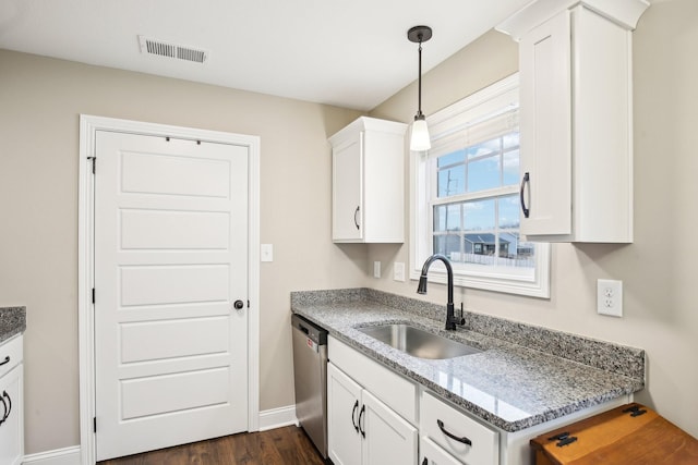 kitchen with dark stone counters, sink, decorative light fixtures, dishwasher, and white cabinetry