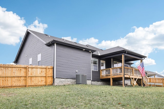 back of house featuring a lawn, central AC, and a deck