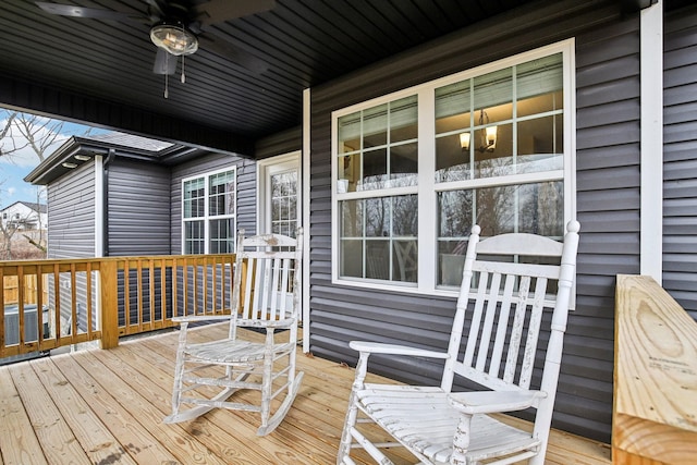 wooden terrace with ceiling fan, cooling unit, and covered porch