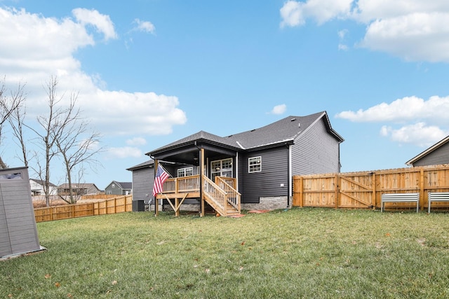 rear view of property with central AC, a deck, and a lawn