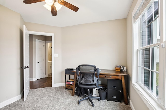 carpeted home office with ceiling fan