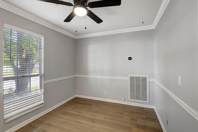 spare room with ceiling fan, hardwood / wood-style floors, a healthy amount of sunlight, and a textured ceiling