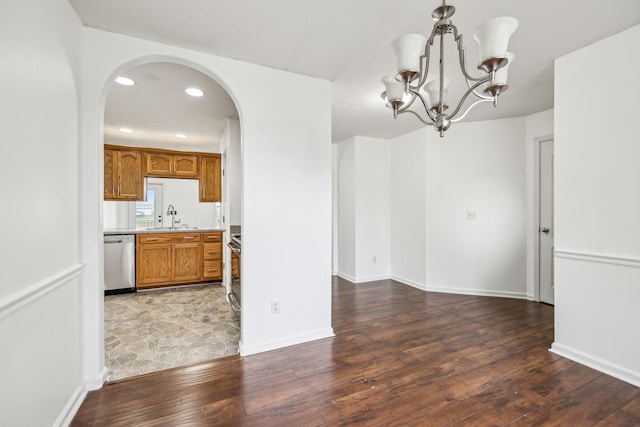 interior space with dark wood-type flooring, sink, and a chandelier