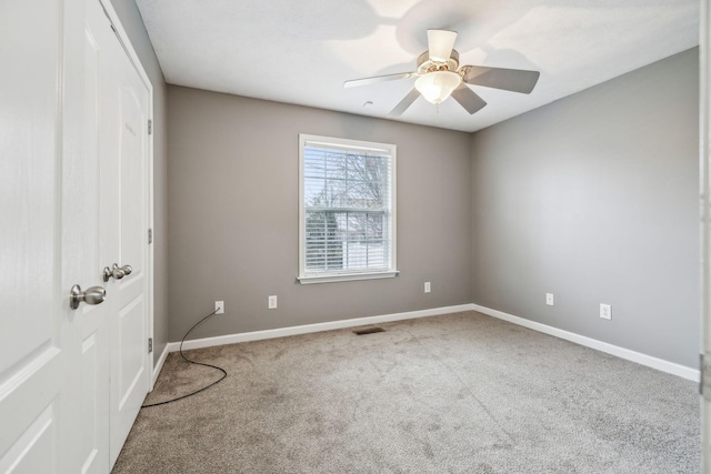 empty room with carpet floors and ceiling fan