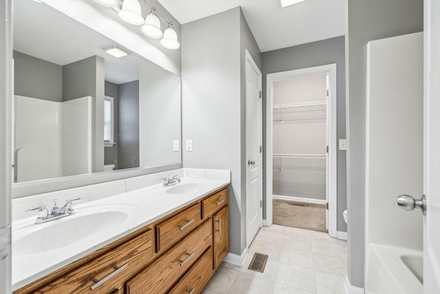 bathroom featuring tile patterned flooring, vanity, and toilet