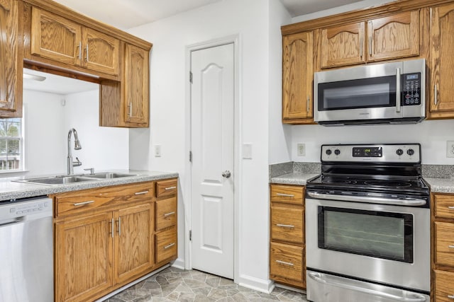 kitchen with sink, light tile patterned floors, and stainless steel appliances