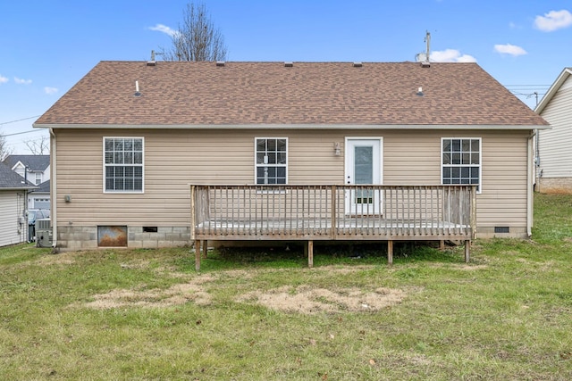 rear view of house with a lawn and a deck