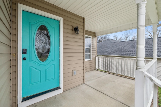 view of exterior entry with a porch