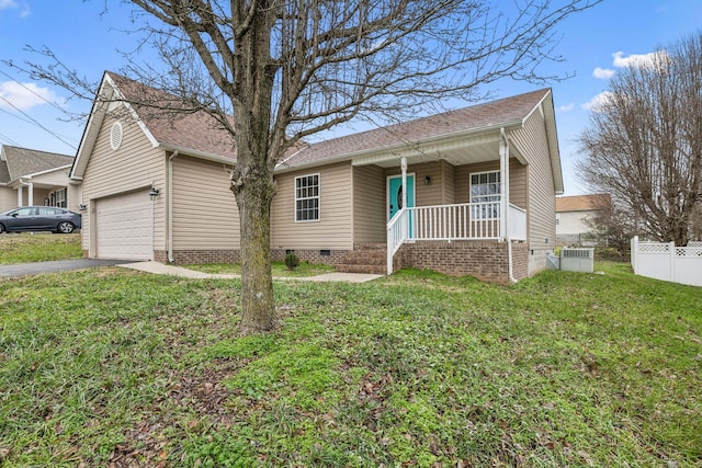 ranch-style home with covered porch, a front yard, and a garage