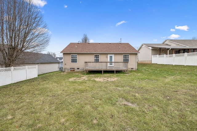 rear view of house featuring a yard and a deck