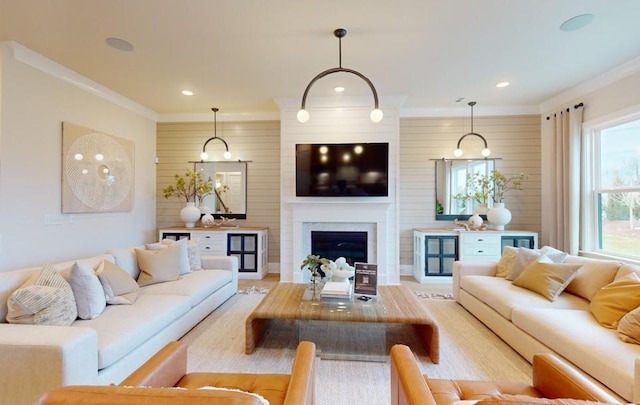 living room with plenty of natural light, crown molding, and wood walls