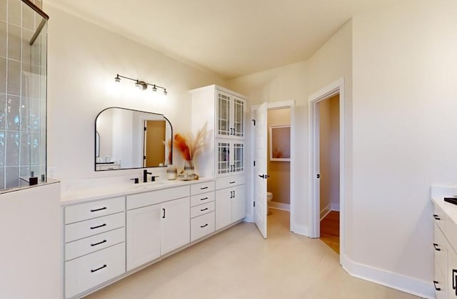 bathroom featuring toilet and vanity