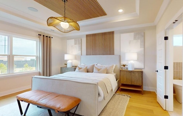 bedroom with crown molding, ceiling fan, a tray ceiling, and light hardwood / wood-style flooring