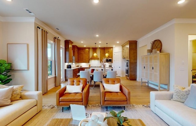 living room with sink, crown molding, and light hardwood / wood-style flooring