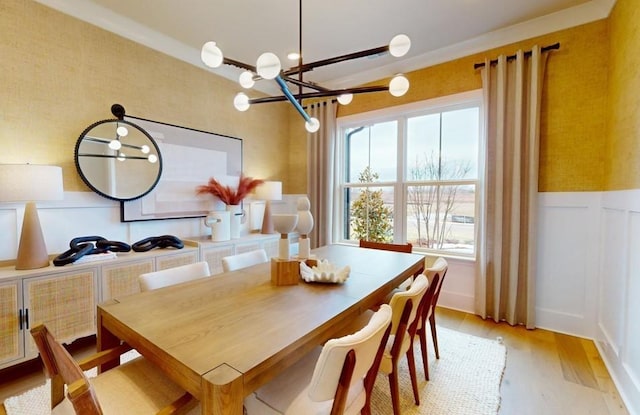 dining room with a healthy amount of sunlight, a chandelier, and light hardwood / wood-style floors