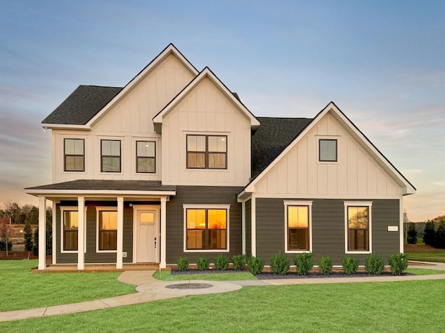 view of front of property featuring covered porch and a yard