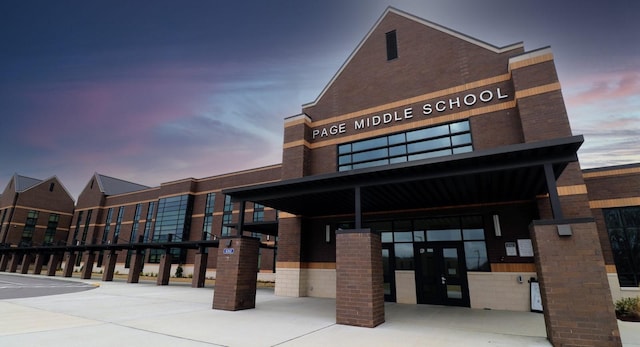 view of outdoor building at dusk