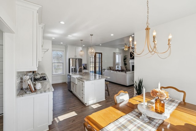 dining area with recessed lighting, baseboards, a notable chandelier, and dark wood finished floors