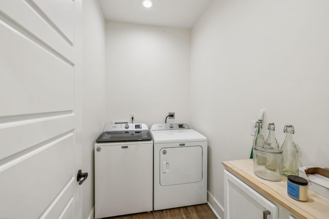 laundry room with washer and clothes dryer, laundry area, and wood finished floors