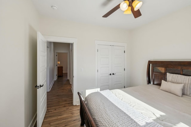 bedroom with a closet, baseboards, ceiling fan, and wood finished floors