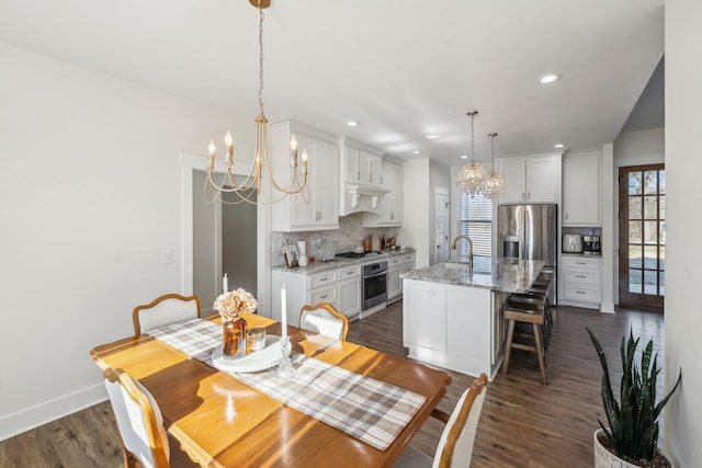 dining area with recessed lighting, baseboards, dark wood-type flooring, and an inviting chandelier