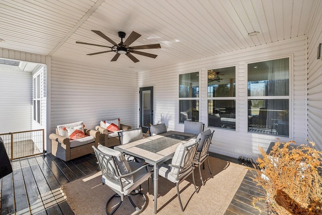 wooden terrace featuring outdoor dining space, a ceiling fan, and outdoor lounge area