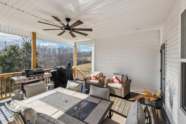 wooden terrace with an outdoor hangout area, area for grilling, outdoor dining area, and ceiling fan