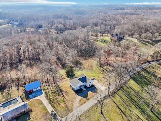 drone / aerial view featuring a forest view