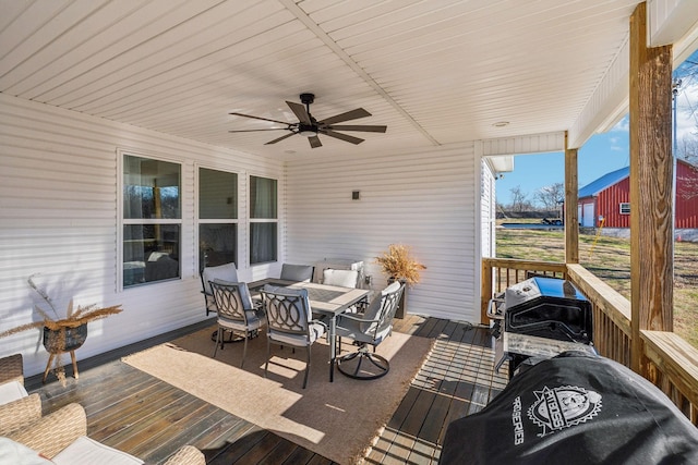 exterior space featuring outdoor dining space, grilling area, a ceiling fan, and a wooden deck