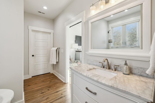 full bathroom with vanity, wood finished floors, visible vents, baseboards, and recessed lighting